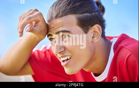 Soccer, sports and sweat with a tired man outdoor for a competitive game or match during the day. Football, fitness and health with a soccer play outs Stock Photo