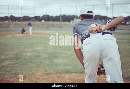 Baseball, baseball player and ball on back on baseball field ready to pitch in competition, game or match. Fitness, sports and pitcher preparing to th Stock Photo