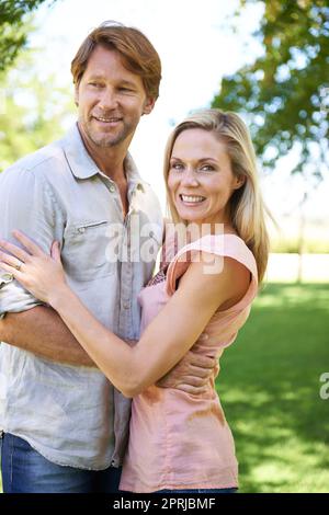 He gives me that feeling. Portrait of an affectionate mature couple enjoying a day in the park Stock Photo