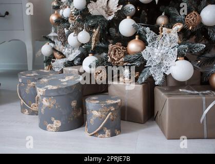 many different boxes with gifts under the tree Stock Photo