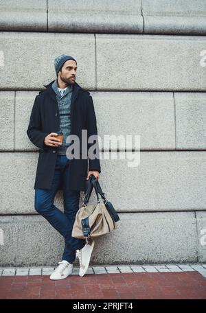 Urban fashion. a fashionable young man leaning against a building in an urban setting. Stock Photo