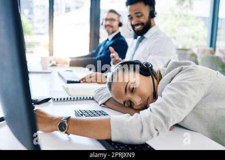 Burnout, tired and sleep at desk with call center employee at desk in customer service, ecommerce or telemarketing company. Business woman, exhausted and overworked customer support agent in office Stock Photo