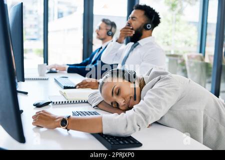 Tired, sleeping in call center and team burnout while giving customer service, consulting online and working at telemarketing company. Bored, sleep and fatigue employees in crm at startup agency Stock Photo