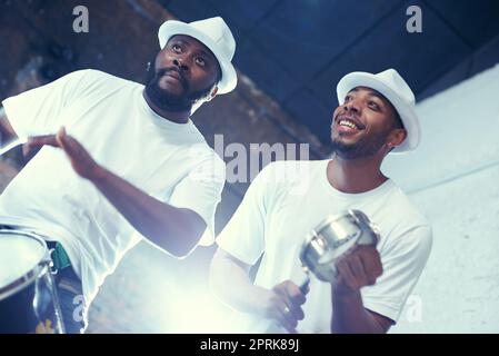 Feeling those Brazillian beats. a band playing their percussion instruments in a Brazilian setting Stock Photo