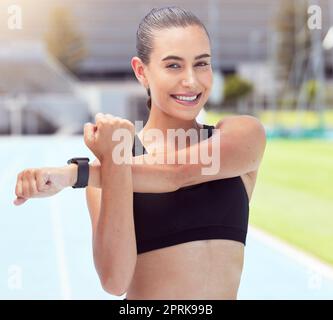 Fitness woman portrait, stretching arms and training on sports track for marathon, exercise and workout in stadium arena outdoor. Happy, smile and str Stock Photo