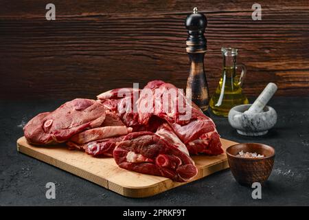 Assortment of raw fresh lamb meat on wooden tray Stock Photo