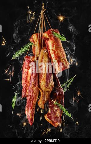 Composition of assortment of air dried and smoked lamb and beef meat on hanger Stock Photo