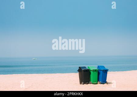 Three Colorful Plastic Waste Containers On Wheels For Separate Collection Of Garbage. Containers For Temporarily Storing Waste. Dustbins, Garbage Cans Stock Photo