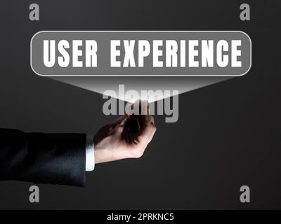Sign displaying User Experience, Business approach how a person reacts and feels after using a specific product Businessman in suit holding tablet sym Stock Photo