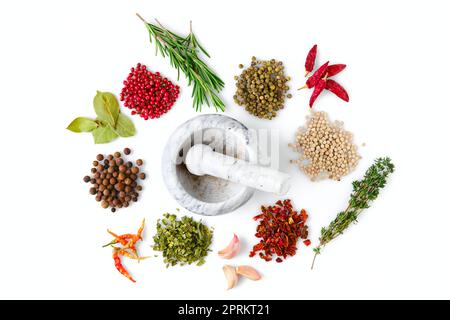 Various seasonings and herbs scattered on white background Stock Photo