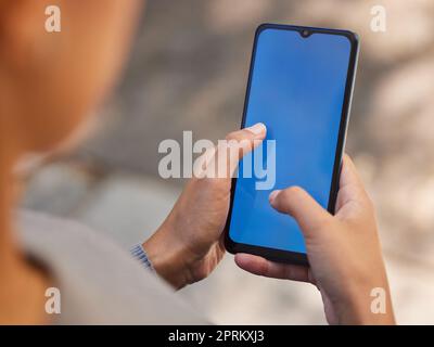 Phone, woman and green screen mock up for brand advertising, marketing app or mobile product website networking. Close up of girl holding smartphone, Stock Photo