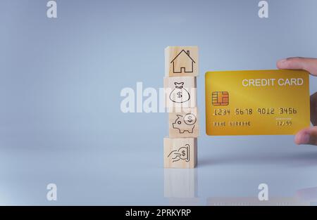 Concept of selling a house. A hand is holding credit card on a white background. Real estate agent offer house, property insurance and security, affor Stock Photo