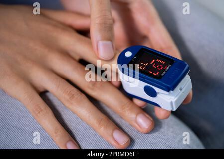 African Hand Pulse Heart Rate And Oximeter Stock Photo