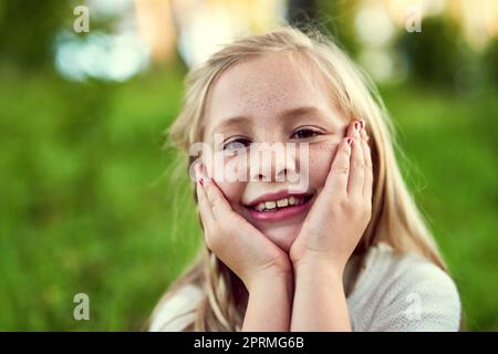 The best days are spent outdoors. Portrait of a young girl enjoying some time outdoors. Stock Photo