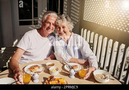 No better way to start the day. a happy senior couple having a leisurely breakfast on the patio at home. Stock Photo