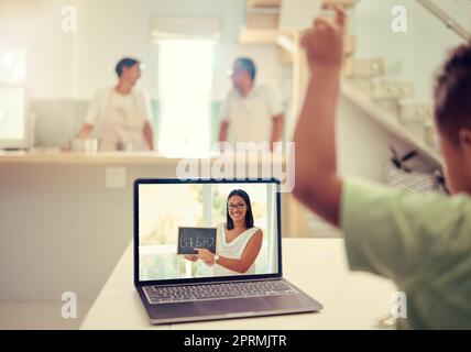 Math education, e learning and teacher on a video call with a school child in covid pandemic lockdown at home. Young, help and creative student in a virtual lesson via a laptop online with tutor Stock Photo
