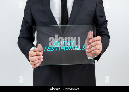 Text caption presenting Client Testimonials, Word Written on Various Engineered Databases Softwares Applications Businessman Holding Transparent Glass Stock Photo