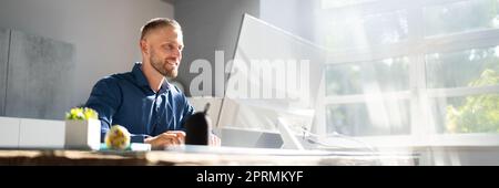 Employee Working On Desktop Computer Stock Photo