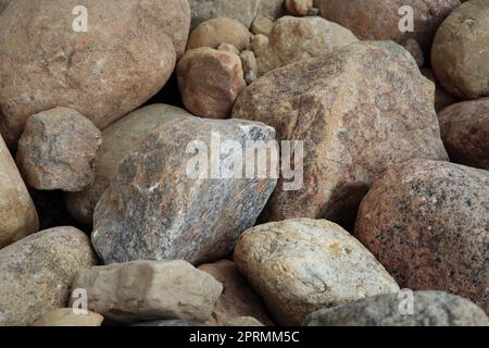A pile of gray stones together forming a texture. Natural stones texture. gray rocks. Stone photography. Natural textures. Stacked rocks and stones. Pile of rocks Stock Photo