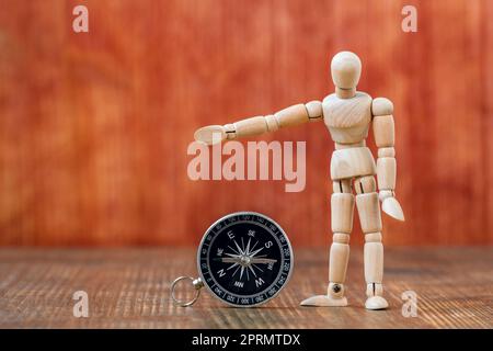 Dummy with compass showing right direction to go Stock Photo