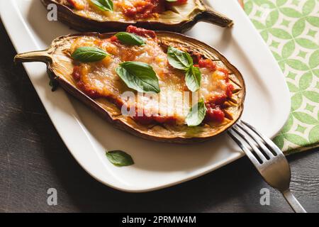 baked eggplant with tomatoes and mozzarella and basil Stock Photo