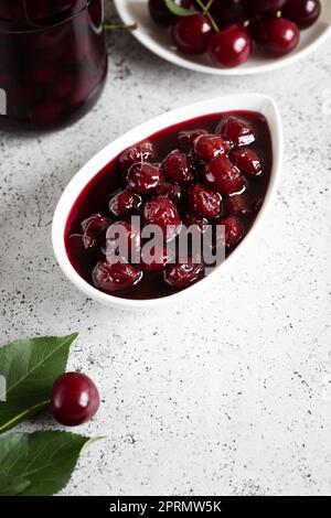 cherry jam and fresh cherries in a bowl, homemade preserves Stock Photo