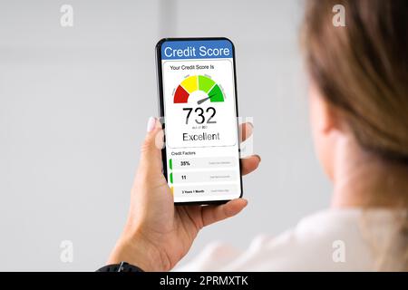 Woman Holding Smart Phone Showing Credit Score Application Stock Photo