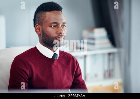 Focused on the task at hand. a young businessman working at his desk in an office. Stock Photo