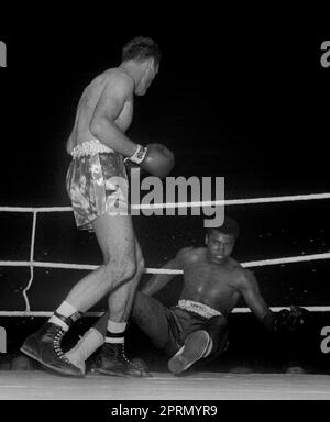 File photo dated 18/6/1963 of Cassius Clay, now Muhammad Ali, being knocked down by Henry Cooper during their fight at Wembley London. Issue date: Thursday April 27, 2023. Stock Photo