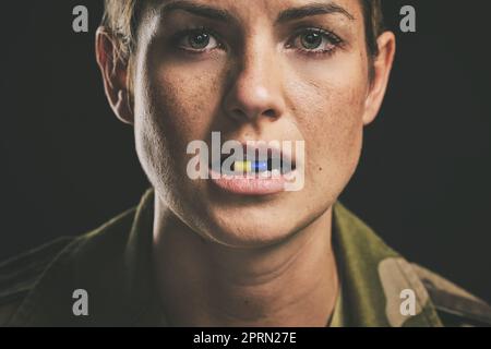 Medicine, medical drugs and military woman with tablet in mouth for ptsd, depression or anxiety against black studio background. Portrait of a soldier Stock Photo