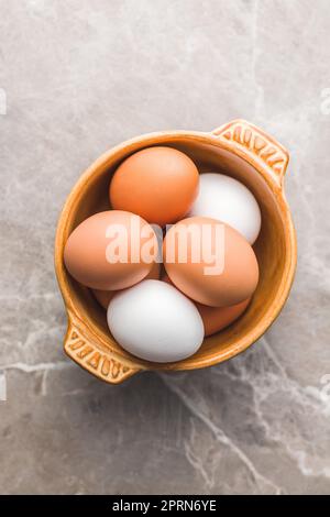 Whole chicken eggs in the bowl. Top view. Stock Photo