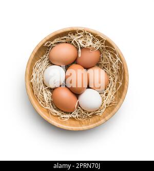 Whole chicken eggs in the basket isolated on white background. Top view. Stock Photo