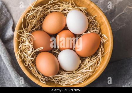 Whole chicken eggs in the basket. Top view. Stock Photo