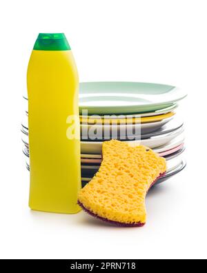 Sponge for washing dishes, plastic bottle and plates isolated on the white background. Stock Photo