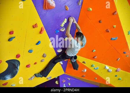 Free Climber Man Climbing On Practice Wall Indoors Stock Photo