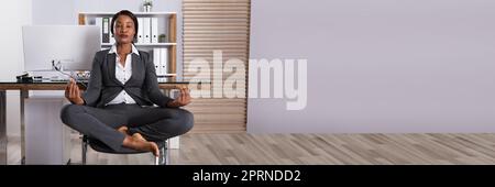 African Business Woman Yoga Meditation in Office Stock Photo - Alamy