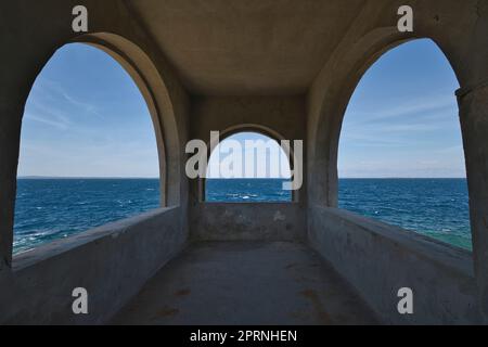 Three arched windows overlooking the sea in Croatia Stock Photo