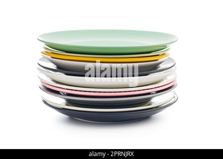 Stacks of colorful porcelain plates isolated on the white background. Stock Photo