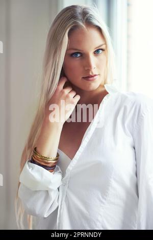 Morning beauty. Portrait of an attractive woman wearing a shirt and standing in her bedroom Stock Photo