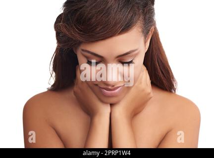 Beauty is about being comfortable in your own skin. a beautiful woman posing against a white background. Stock Photo