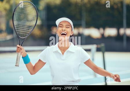 Victory, winner and tennis player woman celebrating with racket after winning a competition or tournament match at an outdoor court. Happy, excited and a fit sports woman after playing a good game Stock Photo