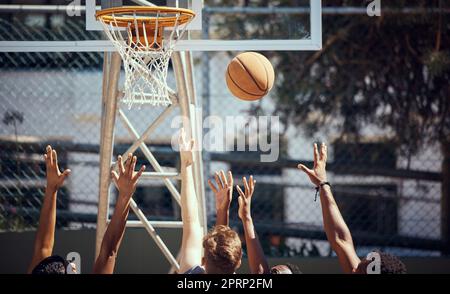 Basketball, sports and fitness with friends on a court for sport, health and exercise outside during summer. Training, workout and recreation with a team of players playing a game or match outdoors Stock Photo