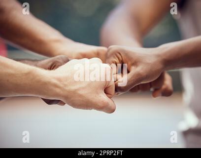 Hands, teamwork and motivation with a team of people joining their fists in a huddle or circle in collaboration. Goal, target and success with a group of friends with a vision together as a community Stock Photo