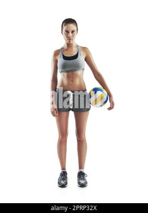 Volleyball is life. Full length portrait of a young female athlete holding a volleyball against a white background. Stock Photo