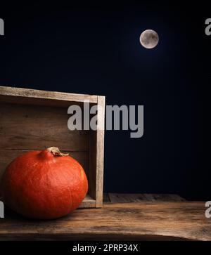 Carved halloween pumpkin Jack o lantern on a rustic wooden plank Stock Photo