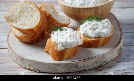 Cottage cheese in a bowl  on a wooden background. Diet and healthy eating concept Stock Photo