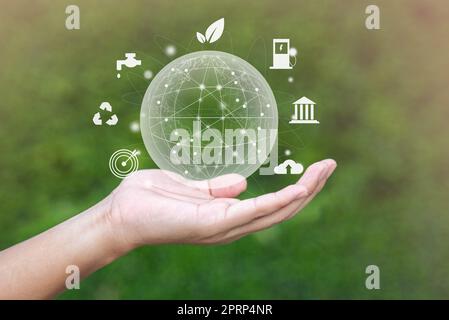 hand with environmental icons CO2 emission reduction icons global warming sustainable development and green business renewable energy clean and friendly environment concept. Stock Photo