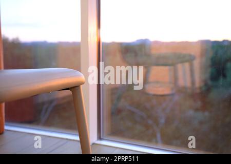 modern bliege chair in empty office space with large window, vintage picture style process,copy space. Stock Photo