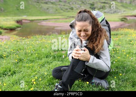 Hiker suffering knee ache after accident alone in nature Stock Photo