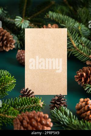 Christmas vertical blank card between fir branches and pine cones on green close up Stock Photo